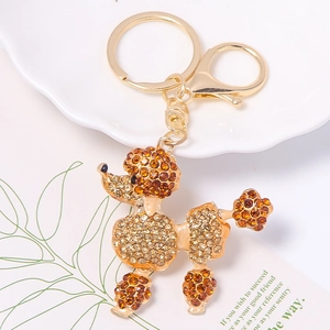 Detailed macro of gold poodle keychain with sparkling brown and champagne rhinestones