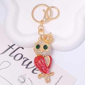 Close-up of crystal owl keychain with gradient rhinestones and golden crown detail