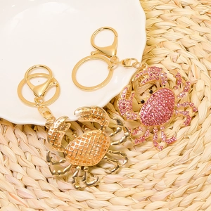 Exquisite crab keychains with orange enamel and pink crystals on gold-plated metal base