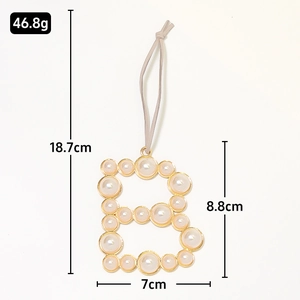 Golden letter B keychain with inlaid pearls, showing 18.7cm length measurements