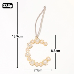 Detail view of pearl letter C keychain with dimensions 18.9cm length and 32.8g weight