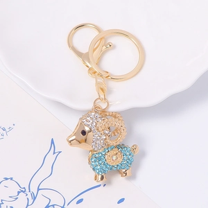 Porte-clés chèvre plaqué or avec strass bleus et blancs étincelants et pièce de monnaie