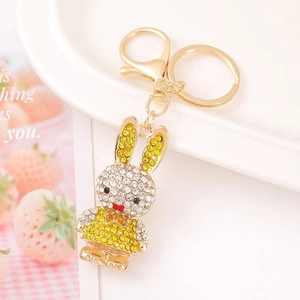 Detailed macro shot of a golden zodiac rabbit keychain encrusted with shiny rhinestones