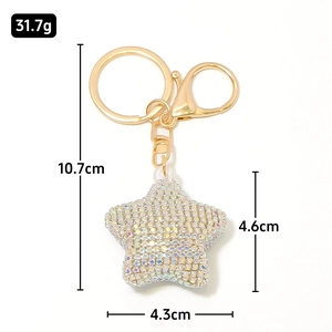 Detail view of rhinestone star keychain showing dimensions 10.7cm length and 31.7g weight