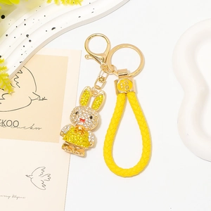 Macro detail of yellow crystal rabbit keychain with gold Fu character charm