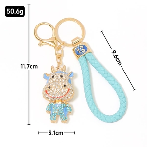 Portachiavi mucca zodiaco cinese con strass e cinturino in pelle intrecciata blu