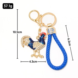 Portachiavi gallo zodiacale dorato con strass e cinturino in pelle intrecciata blu