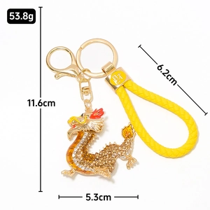 Sparkling Chinese dragon keychain with gold metal plating, rhinestones and yellow strap