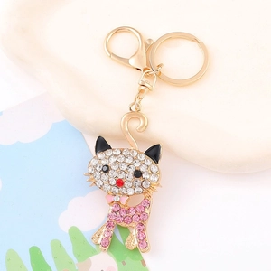 Detailed view of cat keychain with pink and white rhinestones on golden metal base
