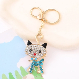 Detailed macro view of cat keychain with blue rhinestones and gold lobster clasp