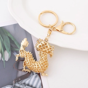 Exquisite golden Chinese dragon keychain with intricate hollow design and metal clasp
