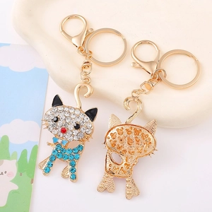 Cat keychain with sparkling rhinestones and bowknot on a gold plated metal alloy base