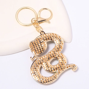 Porte-clés serpent doré du zodiaque avec strass brillants et fermoir mousqueton chic