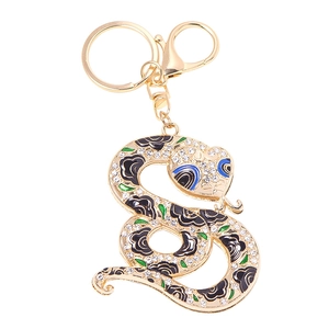 Porte-clés serpent avec base en métal doré, motifs émail noir et strass étincelants