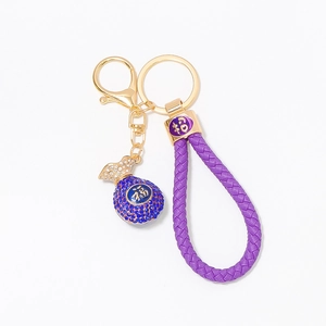 Chinese fortune lucky bag keychain with purple braided cord and blue rhinestones