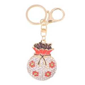 Portachiavi borsa della fortuna dorata con strass bianchi e fiori smaltati cinesi