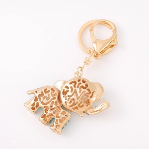 Detailed view of golden elephant keychain with intricate cutouts and a lobster clasp