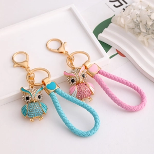 Sparkling owl keychain with rhinestones and woven leather rope in pink and blue colors