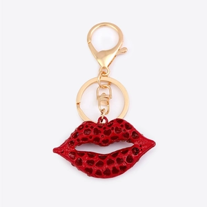 Detail of red hollow heart-pattern lip pendant keychain with golden lobster clasp