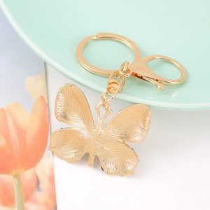 Creative butterfly metal keychain with gold-plated wings and lobster clasp on decor base