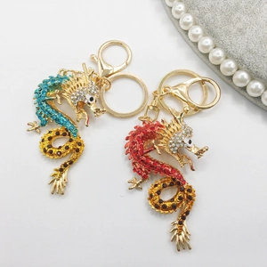 Detailed macro view of Chinese dragon keychains with colorful rhinestones and gold plating