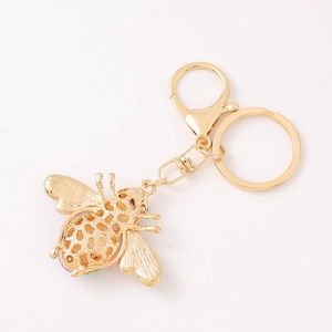 Detailed close-up of hollow gold bee keychain with colorful rhinestones and lobster clasp