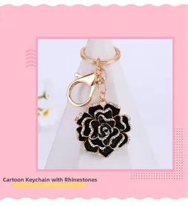 Close-up of elegant black rose keychain with sparkling rhinestones and golden ring hook