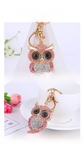 Detail of owl keychain with pink and white rhinestones and gold plating finish