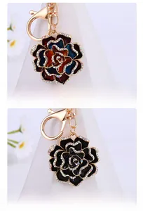 Macro shot of camellia alloy pendant with colorful rhinestones and gold carabiner clip