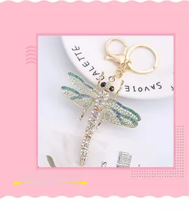 Detailed macro view of dragonfly keychain with sparkling crystals and hollow wings