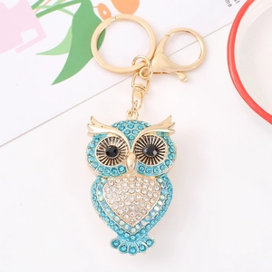 Creative owl keychain featuring blue and white rhinestones on golden metal hardware