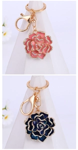 Close-up of rose flower keychains with gold plating and sparkling crystal accents