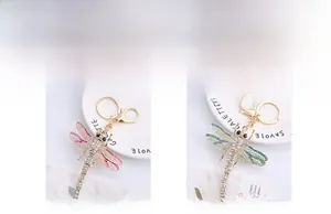 Detail of dragonfly keychain with colorful rhinestones and lobster clasp in two colors