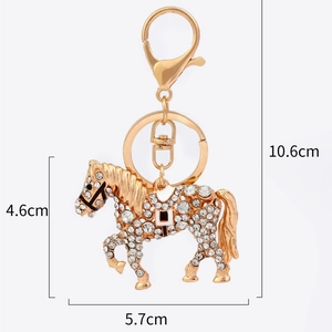 Golden horse keychain with crystals for handbags, measuring 5.7cm wide and 4.6cm high