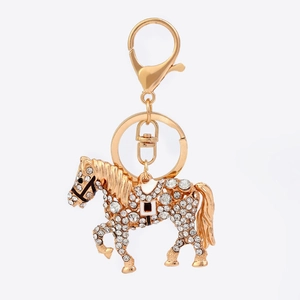 Detailed close-up of a running horse keychain with sparkling rhinestones and gold alloy