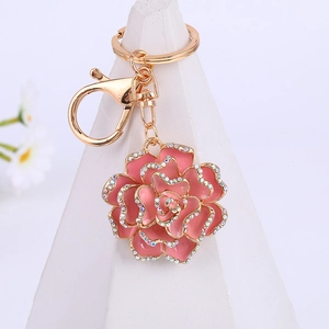 Pink enamel camellia flower keychain with sparkling crystals and gold-tone metal clasp
