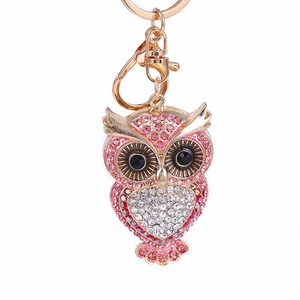 Pink rhinestone owl keychain with rose gold plating and heart-shaped crystal embellishment