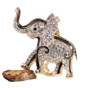 Sparkling elephant keychain with crystal rhinestones and enamel details on a wood stand