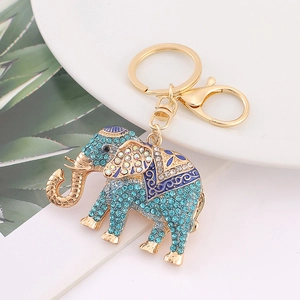 Golden elephant keychain with light blue rhinestones and enamel pattern on white plate