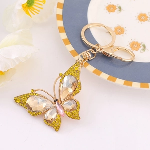 Detailed close-up of a butterfly keychain with yellow rhinestones and champagne gems