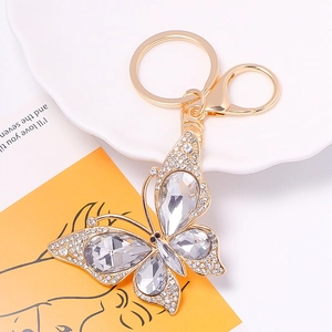 Close-up of golden butterfly keychain with inlaid sparkling crystals and lobster clasp