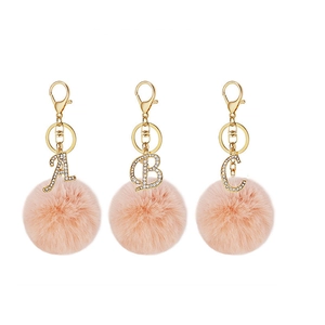 Pink faux rabbit fur ball keychain set with gold rhinestone alphabet A, B and C charms