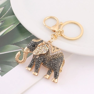Close-up of golden elephant keychain with sparkling grey rhinestones and floral patterns