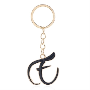 Detailed view of the cursive letter E keychain with black enamel and gold plating finish