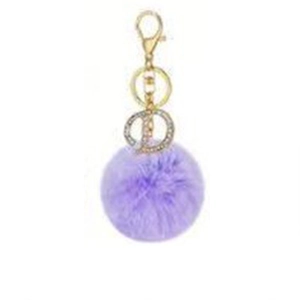 Close-up of a purple faux fur pompom keychain with a sparkling rhinestone letter D charm