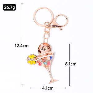 Rose gold cocktail glass keychain with colorful crystals and floral details on white background