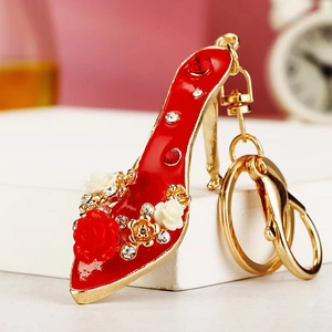 Detailed macro view of red high heel keychain with floral roses and sparkling rhinestones