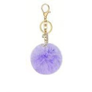 Close-up of purple faux rabbit fur pompom keychain with golden letter J diamond pendant