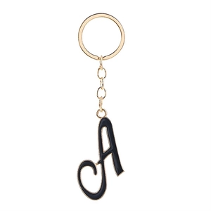 Golden keychain with letter A charm in black enamel and metallic finish details