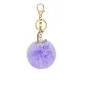 Detail of light purple faux fur pompom keychain with golden rhinestone letter L pendant